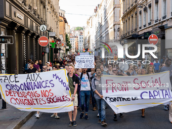 Protesters hold a banner reading Social Front against capital during a protest march in Lyon on June 19, 2017 to protest against Emmanuel Ma...