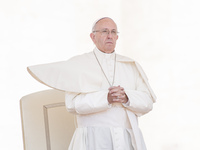 Pope Francis' mantle blows in the wind as he leaves at the end of his weekly general audience in St. Peter's Square, at the Vatican, Wednesd...