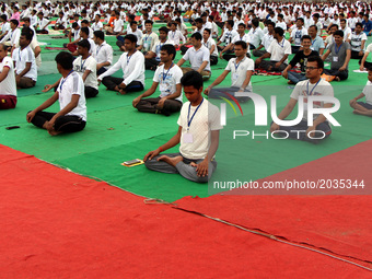 Indian students  perform yoga  to mark World Yoga Day at parade ground during rains, in Allahabad on June 21,2017. (