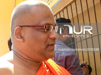 Sri Lankan Buddhist monk Galagodaatte Gnanasara wearing spectacles, arrives at Magistrates court with his lawyers and supporters to surrende...
