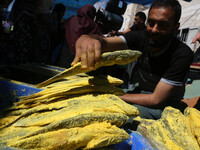 A Palestinian arranges salted fish during preparations for the upcoming Eid al-Fitr feast which is celebrated at the end of the Muslim fasti...