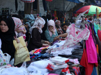 Palestinians buy Clothing, shoes and games  in a market in  Gaza Strip ahead of Eid al-Fitr holiday, which will mark the end of the holy mon...