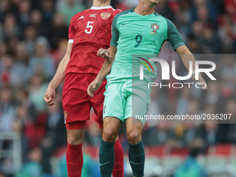Viktor Vasin (L) of the Russian national football team and André Silva of the Portugal national football team vie for the ball during the 20...
