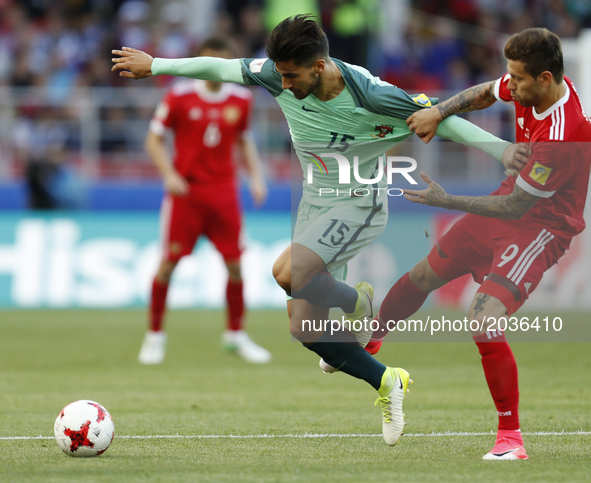 Fedor Smolov (R) of Russia national team and Andre Gomes of Portugal national team vie for the ball during the Group A - FIFA Confederations...
