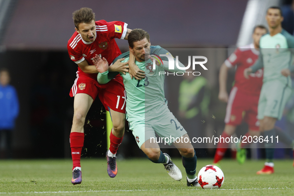 Aleksandr Golovin (L) of Russia national team and Adrien Silva of Portugal national team vie for the ball during the Group A - FIFA Confeder...