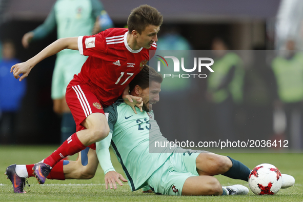Aleksandr Golovin (L) of Russia national team and Adrien Silva of Portugal national team vie for the ball during the Group A - FIFA Confeder...
