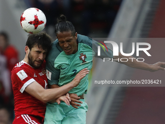 Georgy Dzhikya (L) of Russia national team and Bruno Alves of Portugal national team vie for a header during the Group A - FIFA Confederatio...
