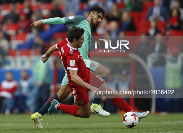 Yury Zhirkov (L) of Russia national team and Andre Gomes of Portugal national team vie for the ball during the Group A - FIFA Confederations...