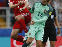 Yury Zhirkov (L) of Russia national team and Adrien Silva of Portugal national team vie for the ball during the Group A - FIFA Confederation...