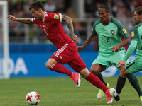 Fedor Smolov (L) of the Russian national football team and Bruno Alves of the Portugal national football team vie for the ball during the 20...