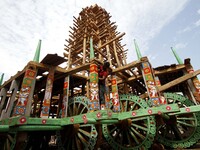 Traditional workers of the Shree Jagannath temple busy to built wooden chariots and applying colors into it it ahead of the Three deities an...