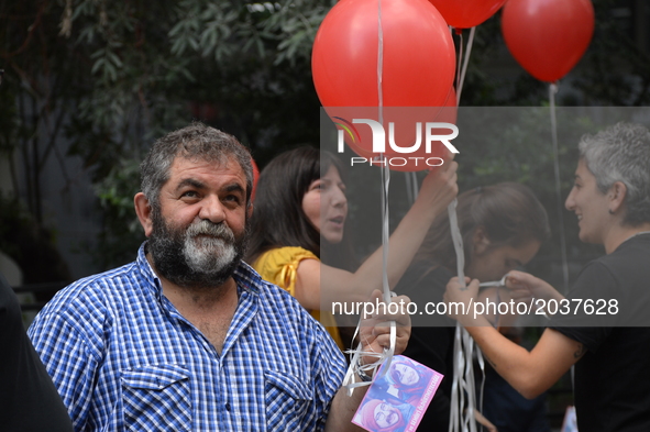 A man holds red balloons to release them into the sky in support of sacked academic Nuriye Gulmen and primary school teacher Semih Ozakca in...