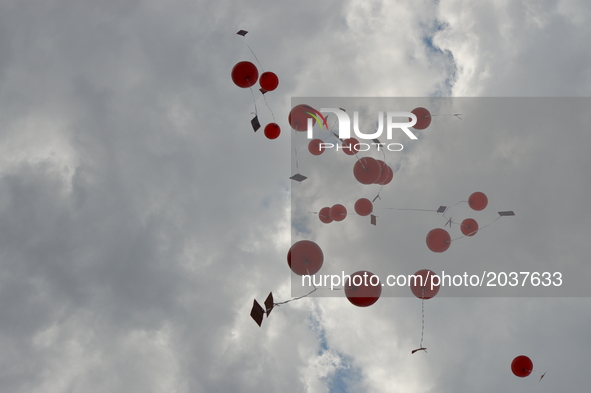People release red balloons into the sky in support of sacked academic Nuriye Gulmen and primary school teacher Semih Ozakca in Ankara, Turk...