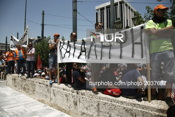 Protesters with banner that reads - Occupation - at the entrance of Greek Parliament during a protest march organized by the Federation of w...