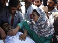 A women wails near the body of Tauseef Ahmed,A civilian in Tengpun, (25 miles) south of Srinagar, Indian Administrated  Kashmir, June 22, 20...
