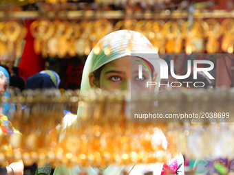 Indian Muslim woman  busy in shopping  at Ramganj Bazar ahead of Eid al-Fitr, during the holy month of Ramadan in Jaipur,Rajasthan, India, 2...