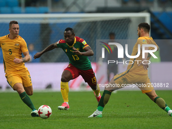 Alex Gersbach (L), Bailey Wright of the Australia national football team and Christian Bassogog (C) of the Cameroon national football team v...