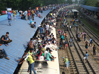 On 23 June 2017 in Dhaka, bangladeshi passengers travel in an overcrowded trains and launch as they head home ahead of Eid ul-Fitr. A large...