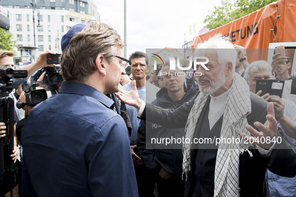 A man wearing a kippah discusses with an organizer of the Al-Quds-Day demonstration in Berlin, Germany on June 23, 2017. 