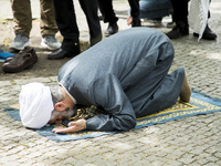 Imam Hamid Reza Torabi and other men pray before the beginning of an Al-Quds-Day demonstration in Berlin, Germany on June 23, 2017. (