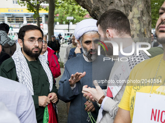 Imam Hamid Reza Torabi (C) and other clerics attend an Al-Quds-Day demonstration in Berlin, Germany on June 23, 2017. (