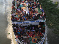 Bangladeshi travelers ride on an over crowed ferry as they go home to celebrate Eid-al-Fitr festival in Dhaka, Bangladesh on June 23, 2017....