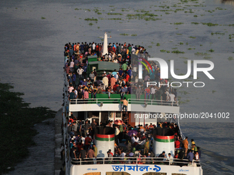 Bangladeshi travelers ride on an over crowed ferry as they go home to celebrate Eid-al-Fitr festival in Dhaka, Bangladesh on June 23, 2017....