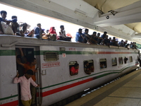Bangladeshi passengers travel in an overcrowded train as they head home to celebrate ahead of Eid-ul-Fitr festival at a railway station in D...