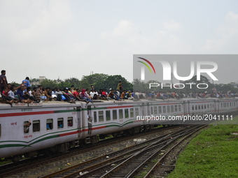 Bangladeshi passengers travel in an overcrowded train as they head home to celebrate ahead of Eid-ul-Fitr festival at a railway station in D...