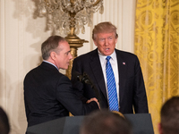 (L-R), VA Secretary David Shulkin, and President Donald Trump shake hands, before signing the Department of Veterans Affairs Accountability...