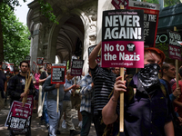Anti-EDL protestors gather near the EDL march, in London, on June 24, 2017. A high pilice presence keeps apart the far-right English Defence...
