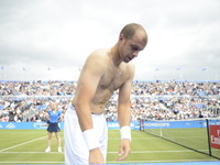 Gilles Muller of Luxembourg, changes his top in the semi final of AEGON Championships at Queen's Club, London, on June 24, 2017. (