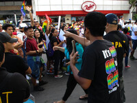 An anti-LGBT (lesbian, gay, bisexual, and transgender) activist leers at passing LGBT members and supporters during the annual LGBT Pride Pa...