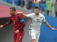 Cristiano Ronaldo (L) of the Portugal national football team and Tommy Smith of the New Zealand national football team vie for the ball duri...