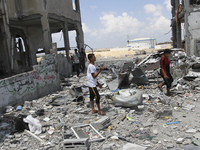 Palestinians inspect in the rubble of their destroyed apartment in a building hit by an Israeli strike in Beit Lahiya, northern Gaza Strip o...