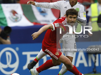 Yury Zhirkov (L) of Russia national team and Jonathan Dos Santos of Mexico national team vie for the ball during the Group A - FIFA Confeder...