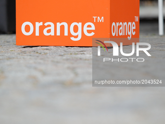 A advertising cube is seen at a stand promoting Orange telecommunication products in the center of the city A Toyata car with both petrol dr...