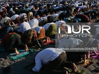 Indonesian Muslims gather to perform Eid Al-Fitr prayer on sand dunes at Parangkusumo beach, Yogyakarta, Indonesia on June 25, 2017. Muslims...