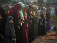 Palestinians attend the morning prayers for Eid al-Fitr celebrations, which marks the end of the holy fasting month of Ramadan, in Gaza City...