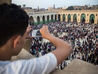 People celebrating Eid al-Fitr feast, marking the end of the Muslim fasting month of Ramadan in Cairo, Egypt. (