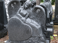 Figures of angels decorate newly made granite tombstones outside the workshop of a tombstone designer in Mississauga, Ontario, Canada. (