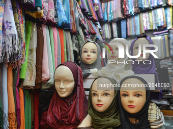 Different hijabs on display for sale inside Casablanca's Old Medina as people make their last purchases and buy presents ahead of Eid Al Fit...