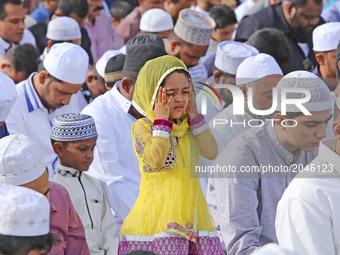 A Sri Lankan Muslim girl offers prayers amid adult Muslim men during the Eid al-Fitr prayers to mark the end of the holy fasting month of Ra...