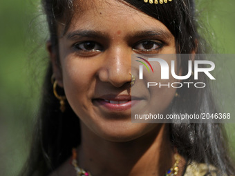 A smiling Portrait of MUSKAN KHATUN, 13yrs old in a traditional attire come to offer ritual morning prayers during celebration of Eid al-Fit...