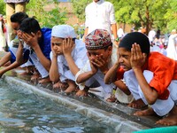 Indian Muslim kids perform 'Wazoo' before offering  Eid al-Fitr prayers at the Idgah Mosque in Delh-Jaipur Highway,Rajasthan  India, Monday,...