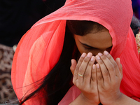 A Sri Lankan muslim girl prays during an Eid al-Fitr event to mark the end of the holy fasting month of Ramadan in Colombo, Sri Lanka Monday...