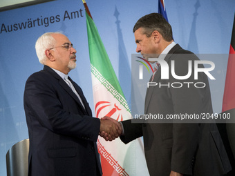 German Vice Chancellor and Foreign Minister Sigmar Gabriel (R) and Iranian Foreign Minister Mohammad Javad Zarif (L) shake hands at the end...