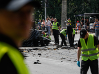 Forensic police experts and military intelligence examine the wreckage of a car in Kyiv, Ukraine, June 27, 2017. The commander of Ukraine's...