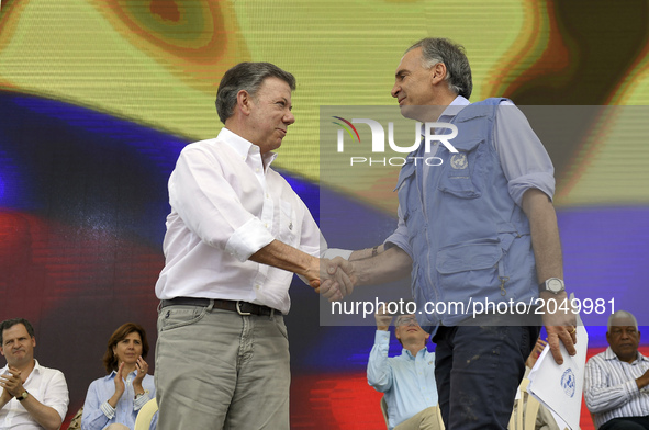 Image provided by the Presidency of Colombia shows Colombian President Juan Manuel Santos (L, front), shaking hands with the head of the Uni...