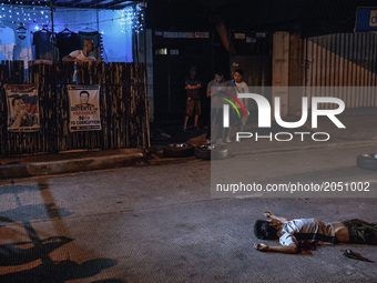 A firearm is seen next to body of a man who was shot dead by police after engaging in a shootout in Quezon city, north of Manila, Philippine...